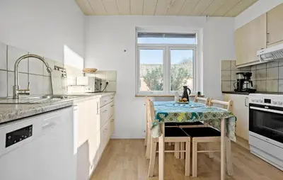 a kitchen with a table with a table cloth on it at 2 Bedroom Nice Home In Roslev in Roslev