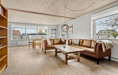 a living room with a couch and a table at 4 Bedroom Awesome Home In Thisted in Thisted