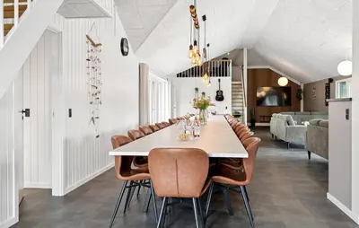 a dining room with a long table and chairs at Stunning Home In Spøttrup With Sauna in Spottrup