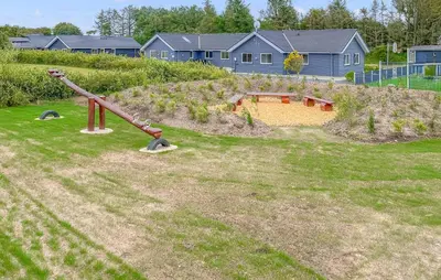 a playground in a yard with a slide at Stunning Home In Spøttrup With Sauna in Spottrup