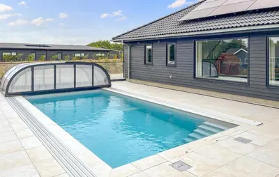 a swimming pool in front of a house at Stunning Home In Spøttrup With Sauna in Spottrup