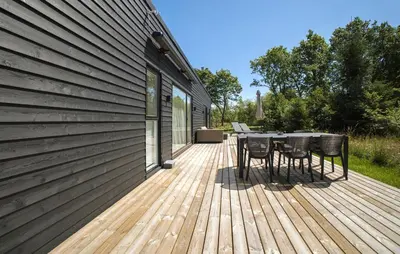 a wooden deck with a table and chairs on it at 2 Bedroom Pet Friendly Home In Vemb in Vemb