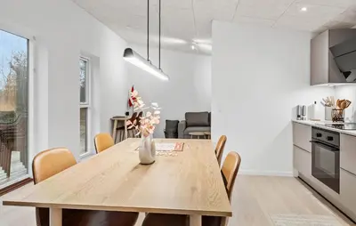 a kitchen and dining room with a wooden table and chairs at 2 Bedroom Pet Friendly Home In Vemb in Vemb