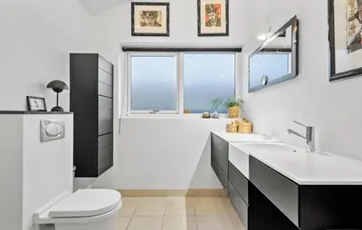 a white bathroom with a toilet and a sink at Gorgeous Home In Nibe With Wifi in Nibe