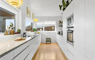 a kitchen with white cabinets and a large window at Gorgeous Home In Nibe With Wifi in Nibe