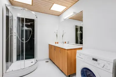 a laundry room with a washer and dryer at 40-Person Holiday Home, With Large Pool Area And Panoramic Views Of The Limfjord in Thyholm