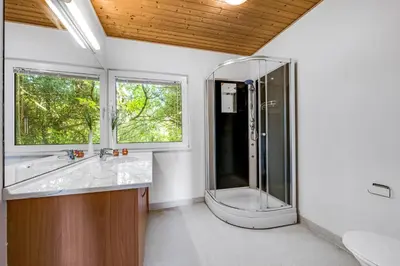 a bathroom with a shower and a sink at 40-Person Holiday Home, With Large Pool Area And Panoramic Views Of The Limfjord in Thyholm