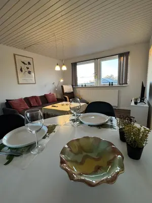 a table with wine glasses and a plate on it at Perfect space for you and your colleague in Vinderup