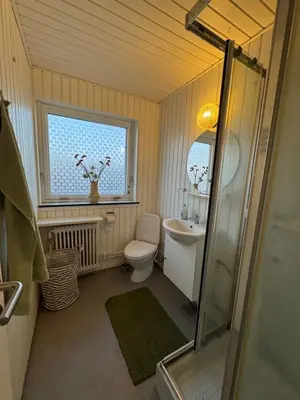a bathroom with a toilet and a sink and a window at Perfect space for you and your colleague in Vinderup