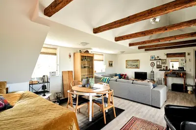 a room with a bed and a table and a couch at Hostel Agger Vandrerhjem in Agger
