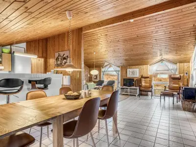 a kitchen and dining room with a wooden ceiling at Holiday Home Annemone - 600m from the sea by Interhome in Torsted