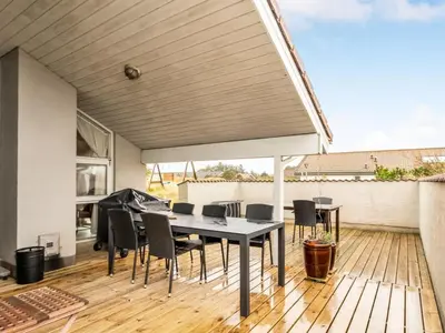 a patio with a table and chairs on a deck at Holiday Home Annemone - 600m from the sea by Interhome in Torsted