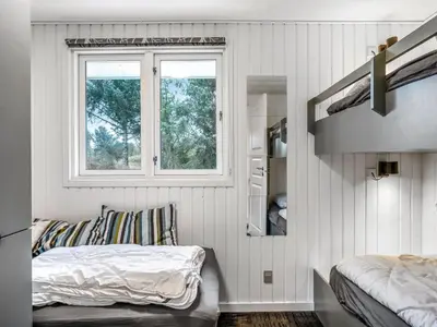a bedroom with a bed and a window at Holiday Home Caya - 750m from the sea by Interhome in Løkken