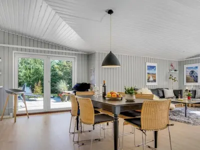 a kitchen with a dining room table and chairs at Holiday Home Quiana - 2km from the sea by Interhome in Pandrup