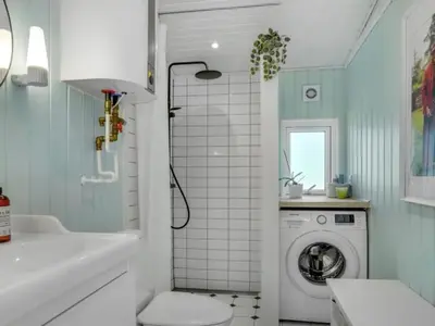 a bathroom with a washing machine and a sink at Holiday Home Quiana - 2km from the sea by Interhome in Pandrup