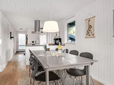 a dining room with a table and chairs at Holiday Home Baldo - 800m from the sea by Interhome in Blokhus