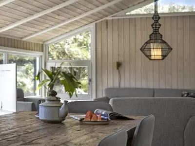 a wooden table with a plate of fruit on it at Holiday Home Erma - 125m from the sea by Interhome in Saltum