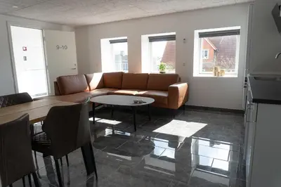 a living room with a couch and a table at Birkelse Hotel og Kro in Birkelse