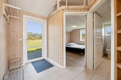 a small room with a bed and a window at Modern Holiday Home From 2017, Located At Lild Strand in Frøstrup
