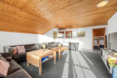 a living room with a couch and a table at Family-Friendly Holiday Home With Pool, Located Close To The North Sea In Vrist in Harboør