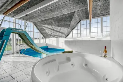 a bath tub in a bathroom with a slide at Family-Friendly Holiday Home With Pool, Located Close To The North Sea In Vrist in Harboør