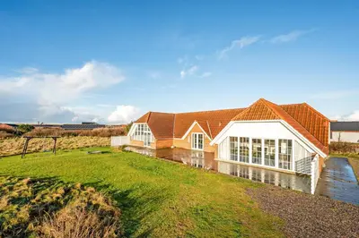 a large house with a large yard in front of it at Family-Friendly Holiday Home With Pool, Located Close To The North Sea In Vrist in Harboør