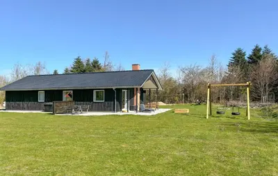 a black building with a playground in a field at Beautiful Home In Spøttrup With Wifi in Spottrup