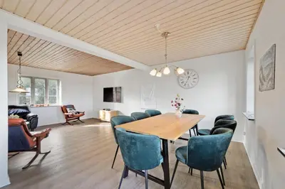 a dining room with a table and chairs at Jørgen's Feriehus in Lemvig