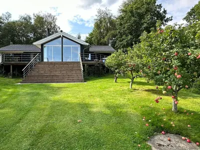 a house with a staircase and an apple tree at Stunning Sunrises Over Harre Vig in Roslev