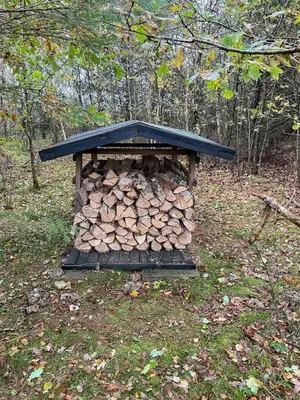 a pile of fire wood in a wooden structure at Nature-Rich Oasis With Views Over The Limfjord in Roslev