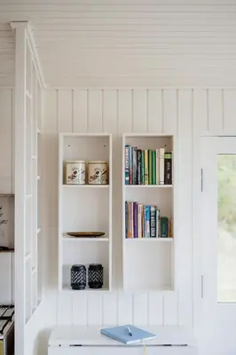 a room with white shelves with books at Summer House With Panoramic Views Of The Limfjord in Lihme