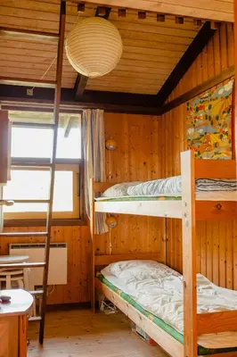 a room with two bunk beds and a table at Family Home In Heather-Clad Landscape in Fjerritslev
