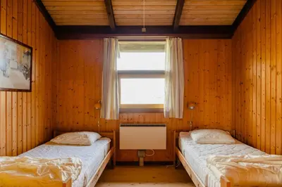 two twin beds in a room with a window at Family Home In Heather-Clad Landscape in Fjerritslev