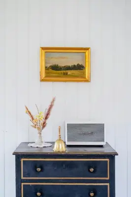 a blue dresser with a laptop on top of it at Experience 