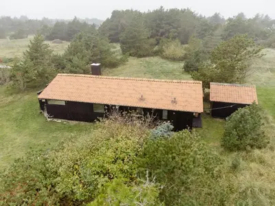 an old barn with a rusty roof in a field at Experience 