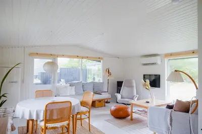 a living room with a table and chairs at Experience 