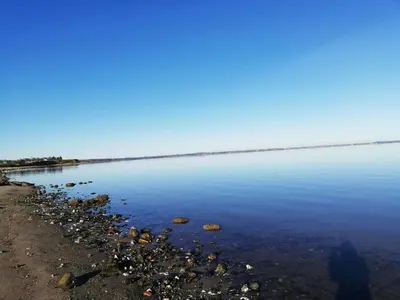 a large body of water with rocks on the shore at Panoramic Views Of Venø Bay At Handbjerg Marina