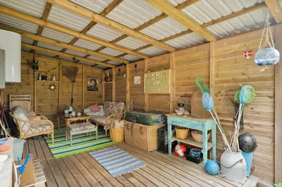 a room with a wooden cabin with a couch and a table at Lifestyle Near Sea And Town in Nykøbing Mors