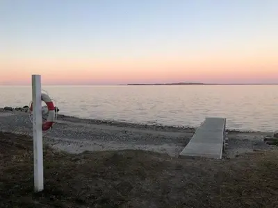 a body of water with a dock and a parking meter at Lifestyle Near Sea And Town in Nykøbing Mors