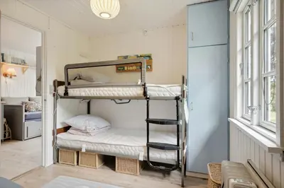 a bedroom with two bunk beds in a room at Lifestyle Near Sea And Town in Nykøbing Mors