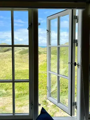 an open window with a view of a field at Luxury With Pool In Dunes Near Løkken in Løkken
