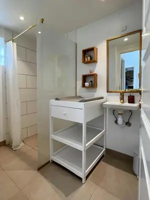 a white bathroom with a sink and a mirror at Luxury With Pool In Dunes Near Løkken in Løkken