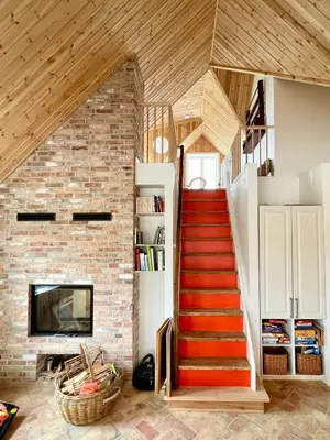 a staircase in a house with a brick wall at Luxury With Pool In Dunes Near Løkken in Løkken