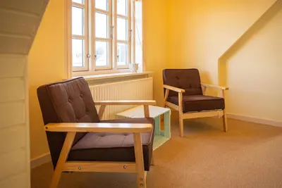 two chairs and a table in a room with a window at Historic Fisherman's Gem With Twist In Klitmøller in Torsted
