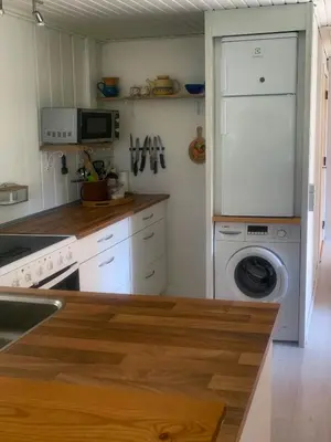 a kitchen with a washing machine and a washer at North Sea's Expanse Near Vorupør in Thisted