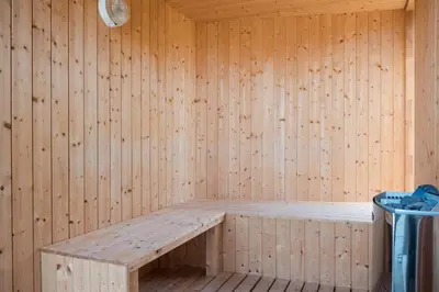 a wooden sauna with a bench in it at Architect-Designed House Close To The North Sea in Vestervig