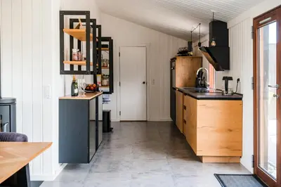 a kitchen with a sink and a counter top at Architect-Designed House Close To The North Sea in Vestervig