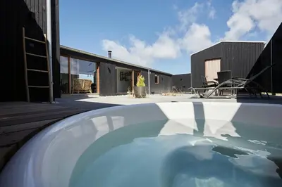 a house with a swimming pool on a deck at Architect-Designed House Close To The North Sea in Vestervig