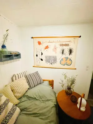 a bedroom with a bed and a table with a picture on the wall at Family House At Kryle Klit Near Wild Nature in Blokhus