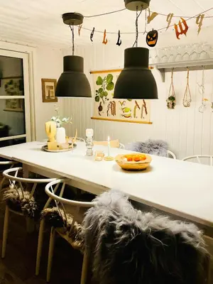 a kitchen with a table with chairs and pendant lights at Family House At Kryle Klit Near Wild Nature in Blokhus